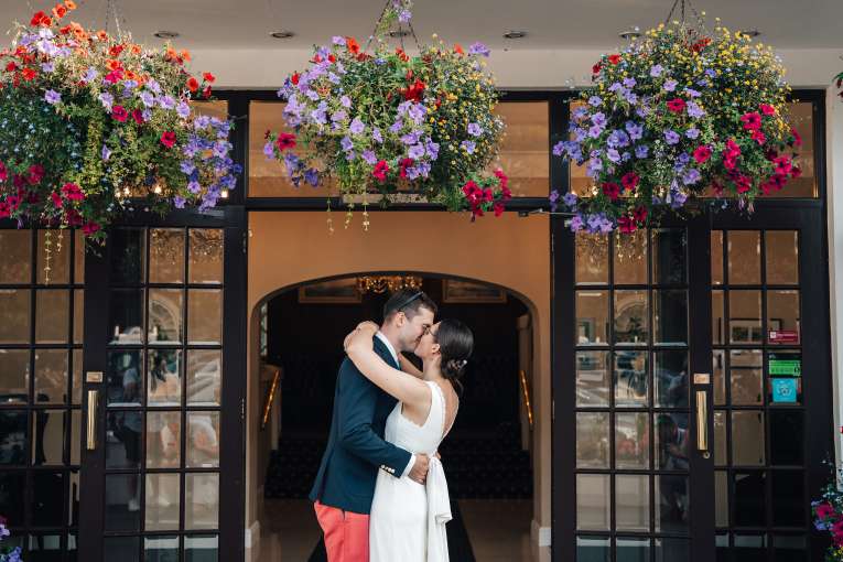 Bride and Groom Kissing at Entrance of Carlyon Bay Hotel 
