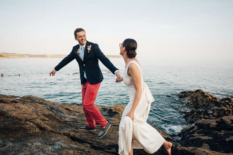 Bride and Groom Laughing Near the Sea