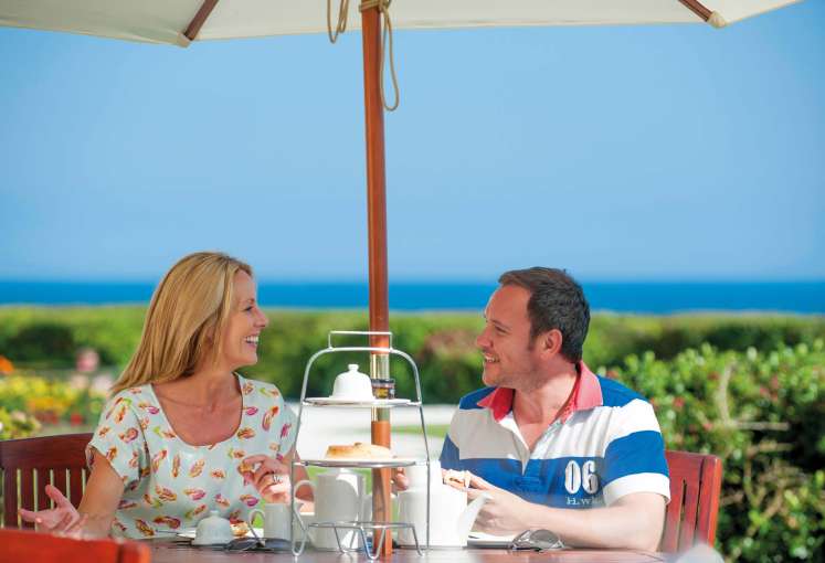 Carlyon Bay Hotel Couple Enjoying Afternoon Tea Outdoors