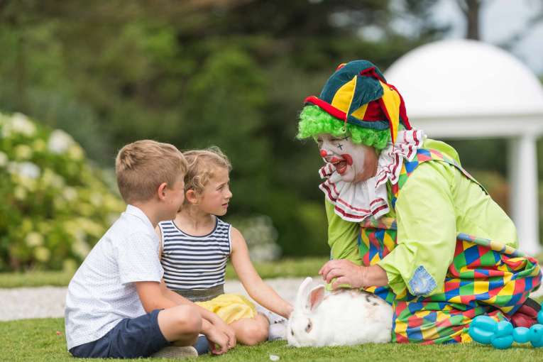 Carlyon Bay Hotel Clown Entertaining Children Outdoors with Bunny Rabbits