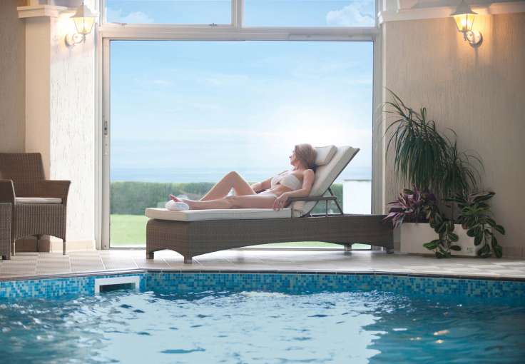 Carlyon Bay Hotel Woman Enjoying View from Lounger by Indoor Swimming Pool