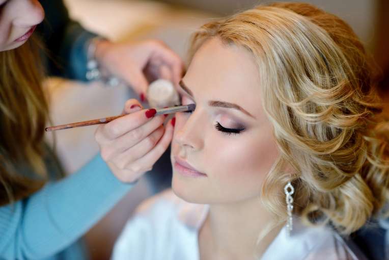 Bride getting ready for the wedding with make up