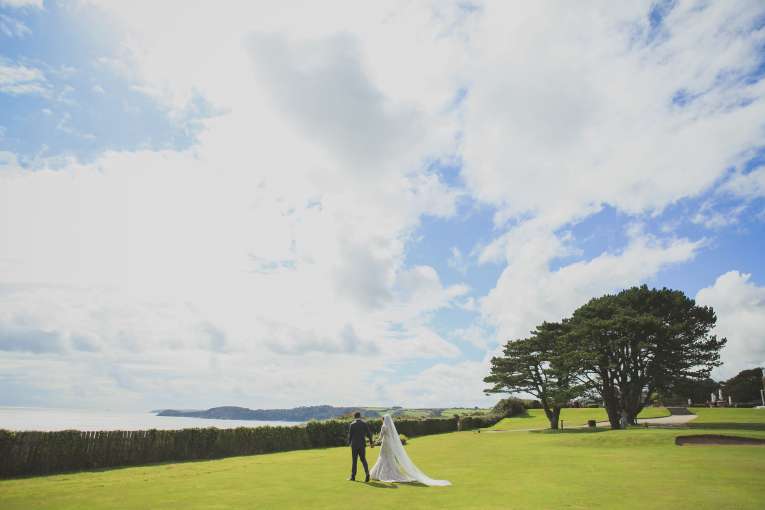Bride & groom in grounds of Carlyon Bay Hotel