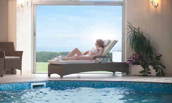 Carlyon Bay Hotel Woman Enjoying View from Lounger by Indoor Swimming Pool