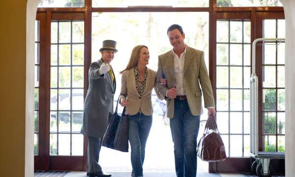 Carlyon Bay Hotel Couple Walking Through Hotel Entrance Greeted by Doorman