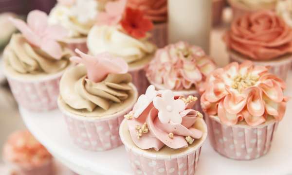 Floral cupcakes on cake stand at a wedding