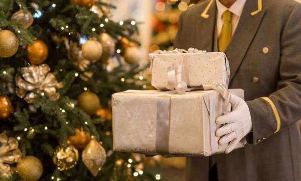 A doorman at the Carlyon Bay Hotel with Christmas Presents