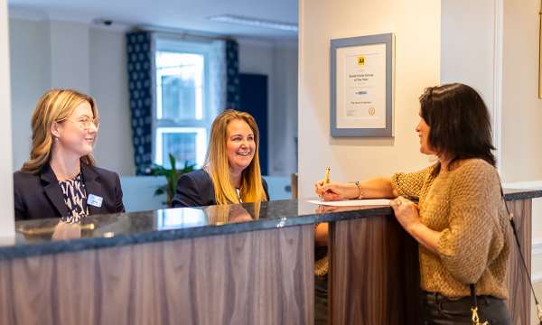 Woman checking in at the reception at Carlyon Bay Hotel
