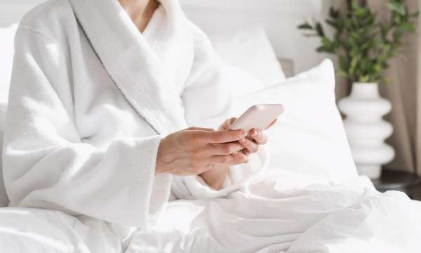 Woman in spa scrolling on her phone