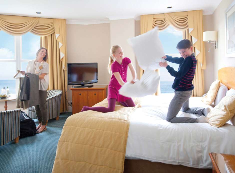 Carlyon Bay Hotel Family Having a Pillow Fight on the Bed