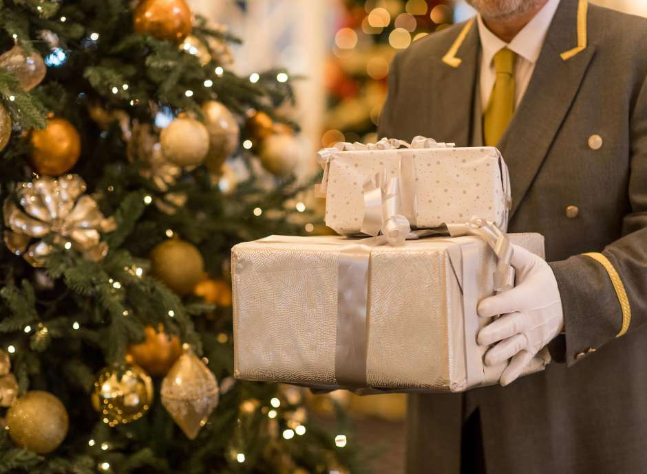 A doorman at the Carlyon Bay Hotel with Christmas Presents