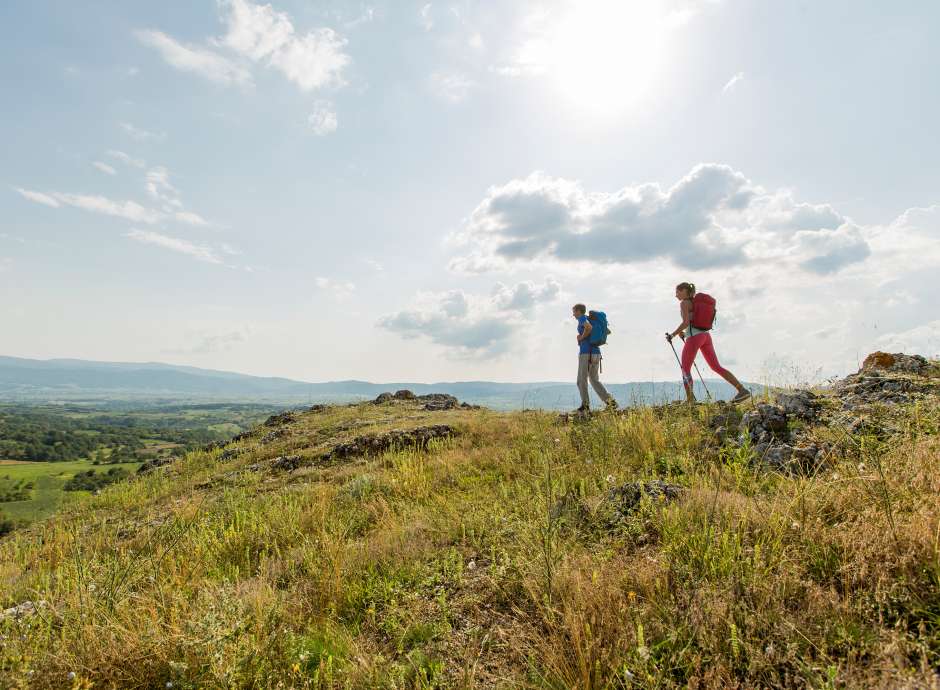 2 people walking on hill