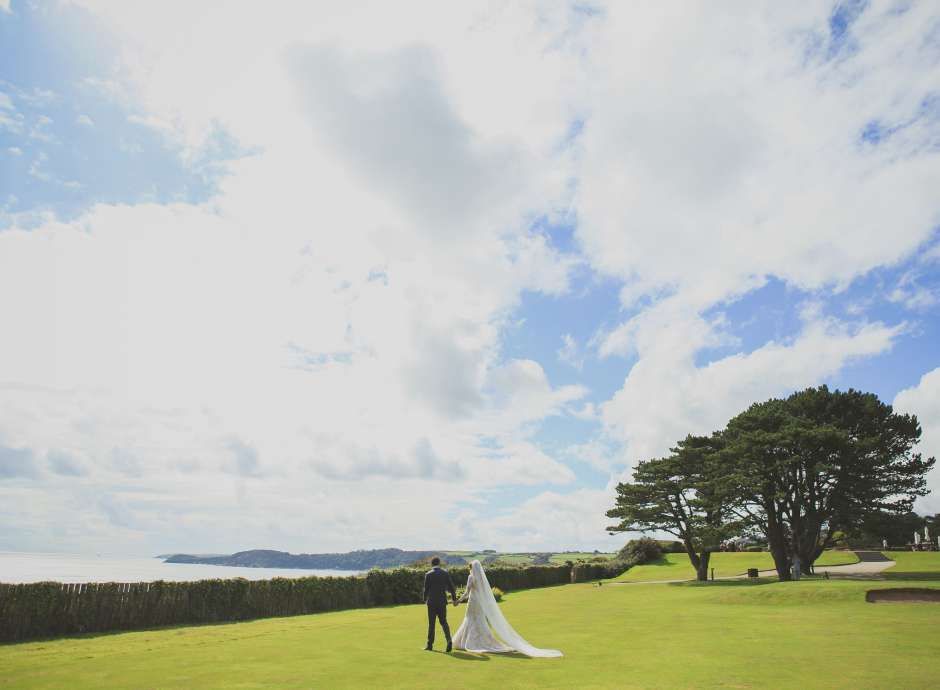 Bride & groom in grounds of Carlyon Bay Hotel