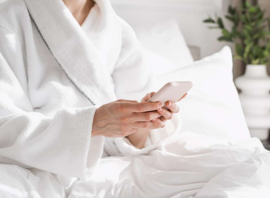 Woman in spa scrolling on her phone