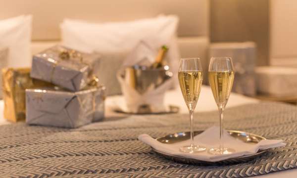 Champagne and Christmas Presents on a bed in the Carlyon Bay Hotel