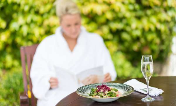 Spa bar woman with lunch on the terrace food and Prosecco