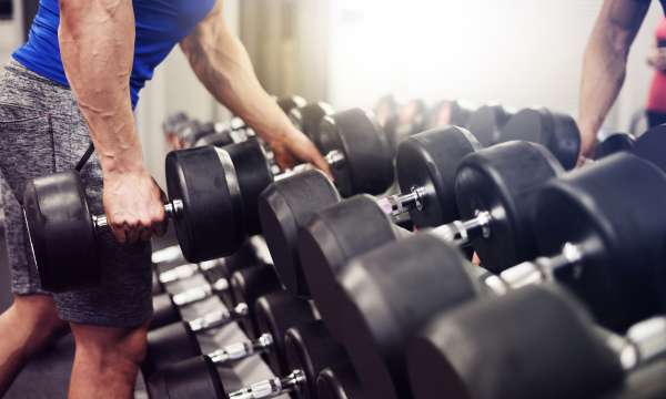 Spa gym man picking up weights