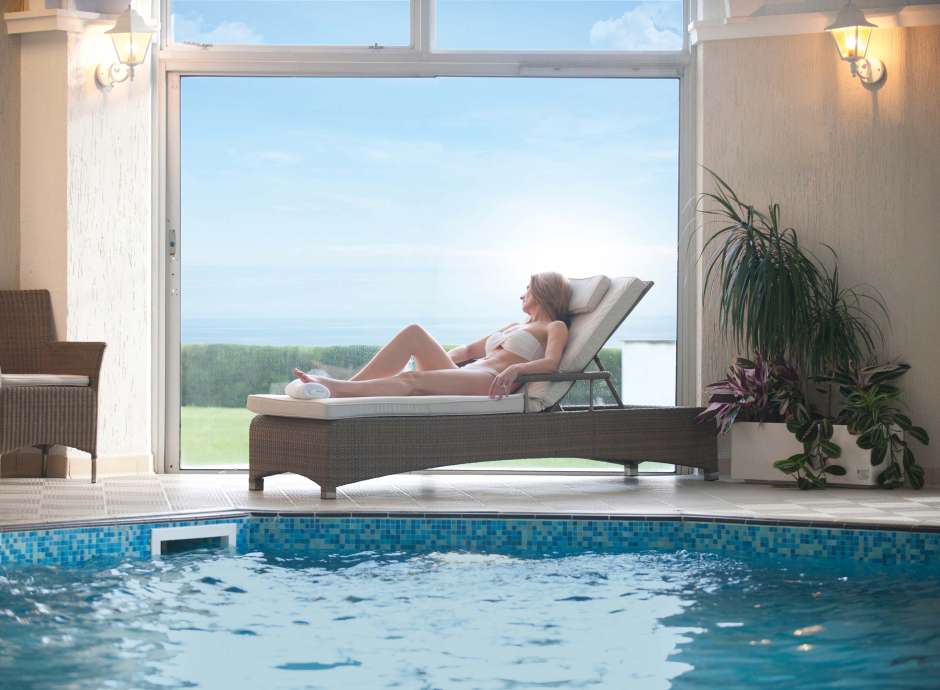 Carlyon Bay Hotel Woman Enjoying View from Lounger by Indoor Swimming Pool