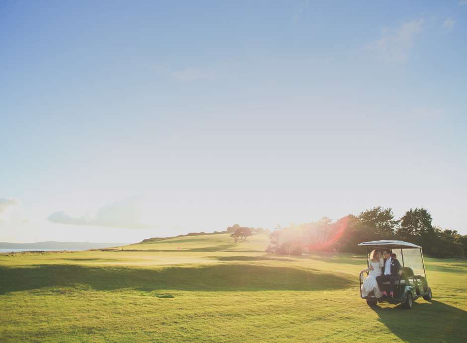 Wedding couple on golf buggy at Carlyon Bay Hotel